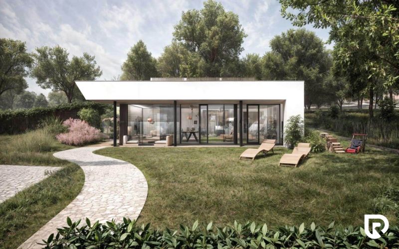 A family house in Častkovce with a glass facade, garden furniture, and a landscaped lawn.