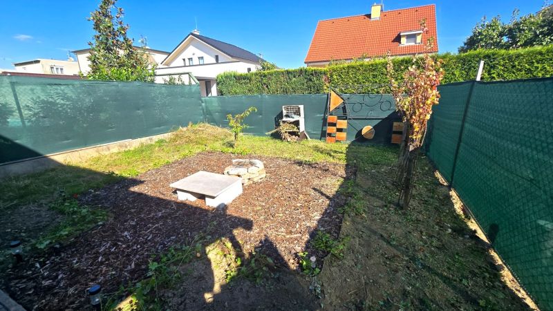 The garden of a family house on Kupeckého Street in Piešťany with a lawn and fencing.
