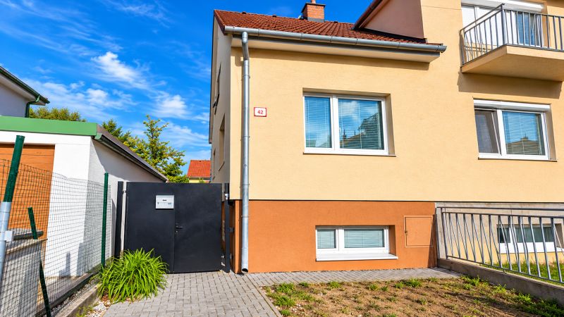 A family house on Kupeckého Street in Piešťany with a fenced yard and an entrance gate.