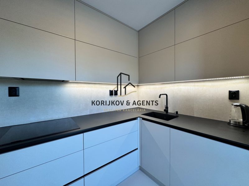 A 3-room apartment kitchen with modern cabinets and LED lighting.