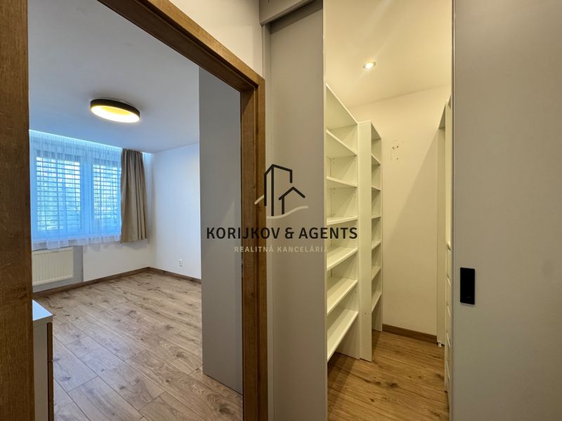 Room and wardrobe in a 3-room apartment with a wooden decor floor.