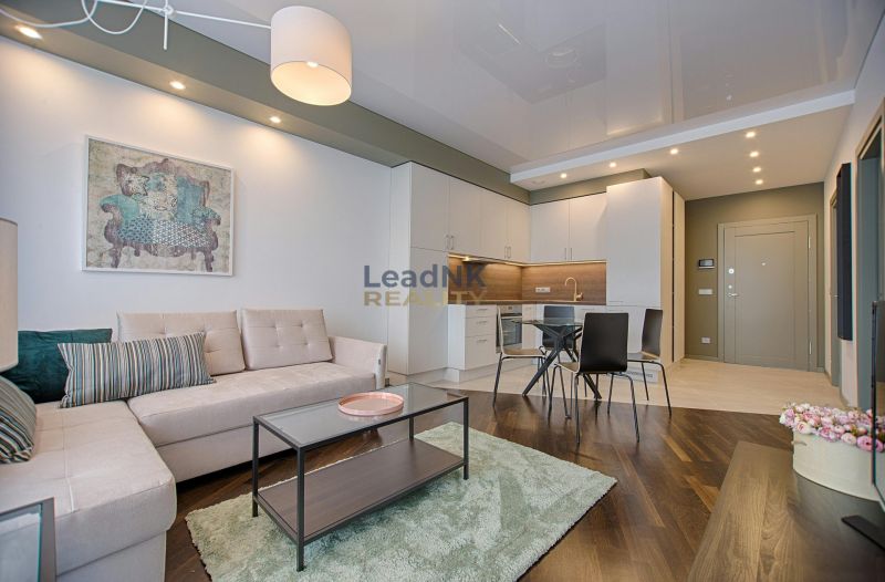 Living room in a 3-room apartment with a wooden decor floor and stylish furniture.