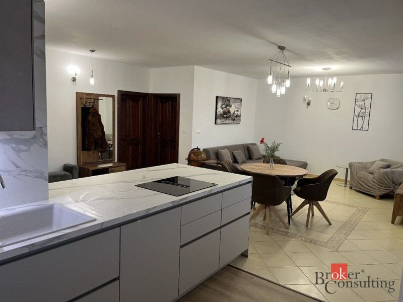 Kitchen and living room with a dining table in a 3-room apartment.