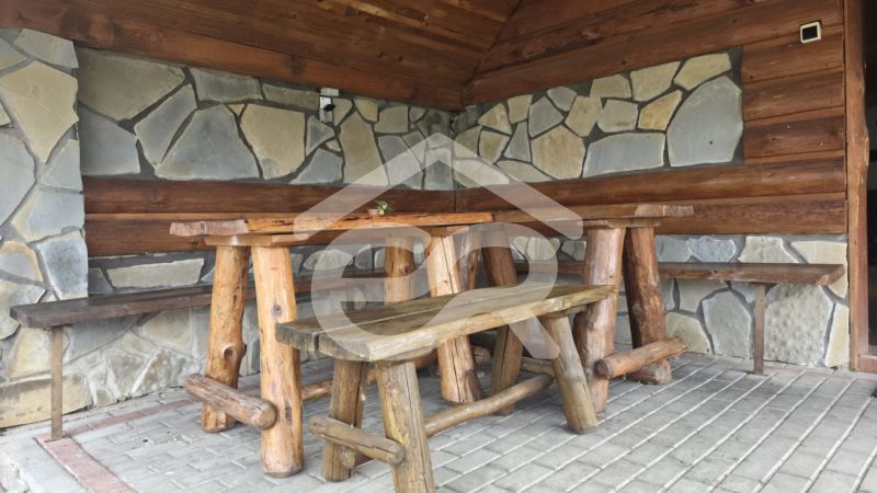 Rustic corner with wooden furniture and a stone wall in the Holiday Apartment.