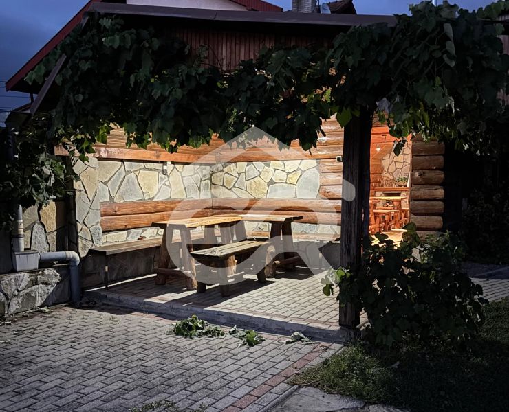 In Podhájska on Hlboká Street, a recreational apartment offers outdoor seating under the vine.