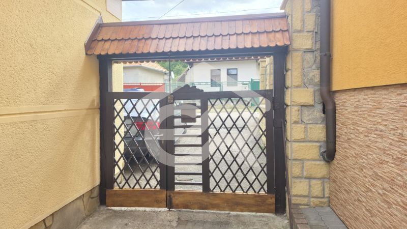 A gate with a lattice pattern leading to the courtyard on Hlboká Street in Podhájska.