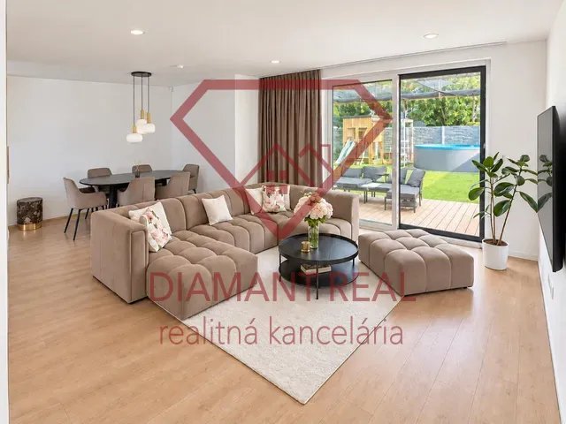 The family house offers a spacious living room with a wooden decor floor and comfortable seating.
