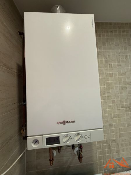 Condensing boiler of the Viessmann brand in the interior of a 2-room apartment on beige tiles.
