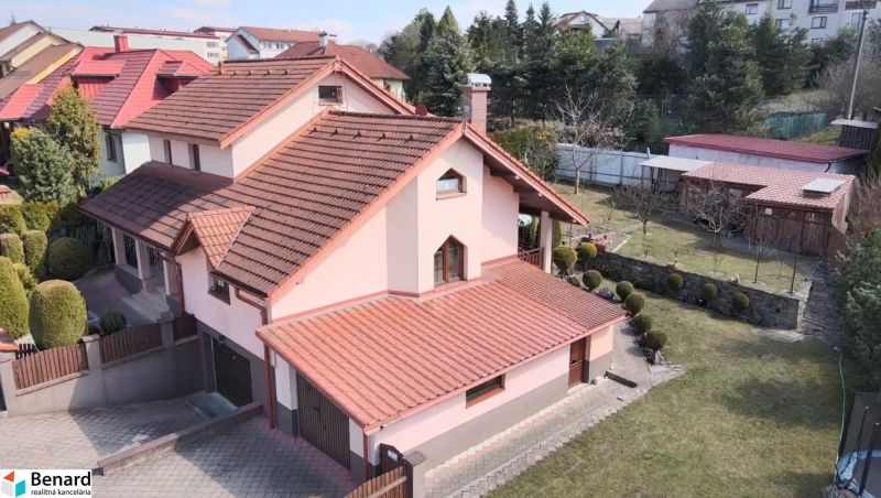 A family house in Stará Ľubovňa with a garden and terrace, surrounded by landscaped greenery.