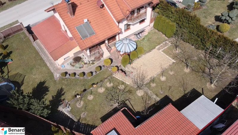 A family house in Stará Ľubovňa with a garden, lawn, gazebo, and solar panels on the roof.
