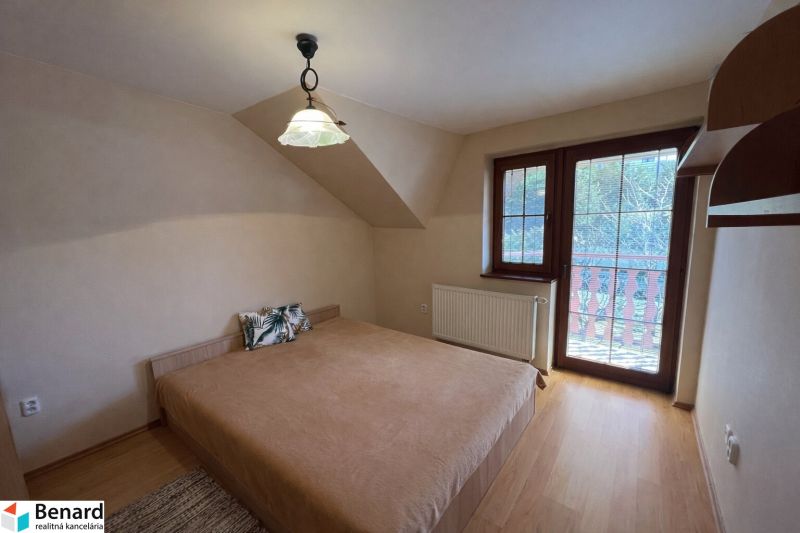 A bedroom in a family house with a bed and a wooden decor floor.