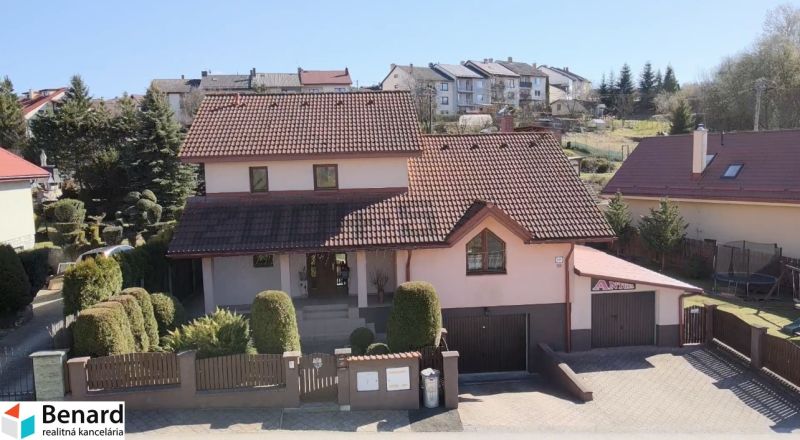 A family house in Stará Ľubovňa with a red tiled roof surrounded by a garden.
