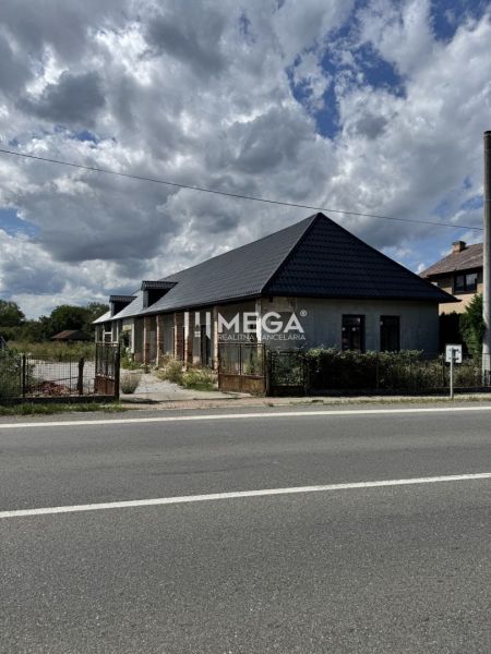 A family house in Nacina Ves with a modern sloped roof, visible from the road.