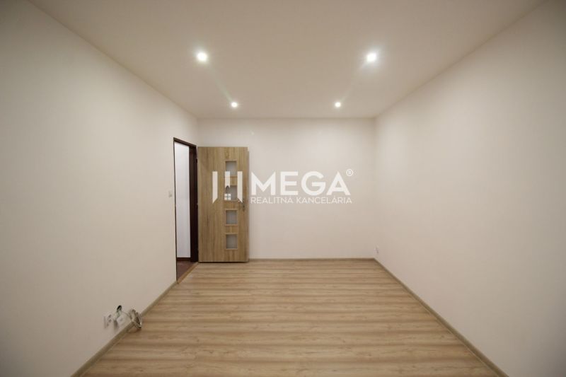 An empty room in a recreational apartment with wooden floor decor and light paint.
