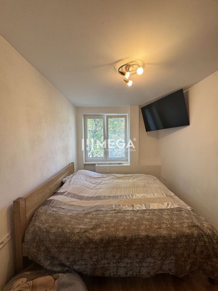 Bedroom in a 3-room apartment with a bed, television, and ceiling light.