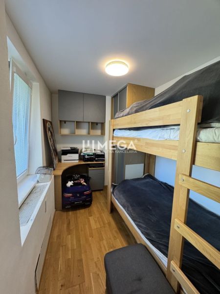 Bunk bed, work desk, and floor with wooden decor in a 3-room apartment.