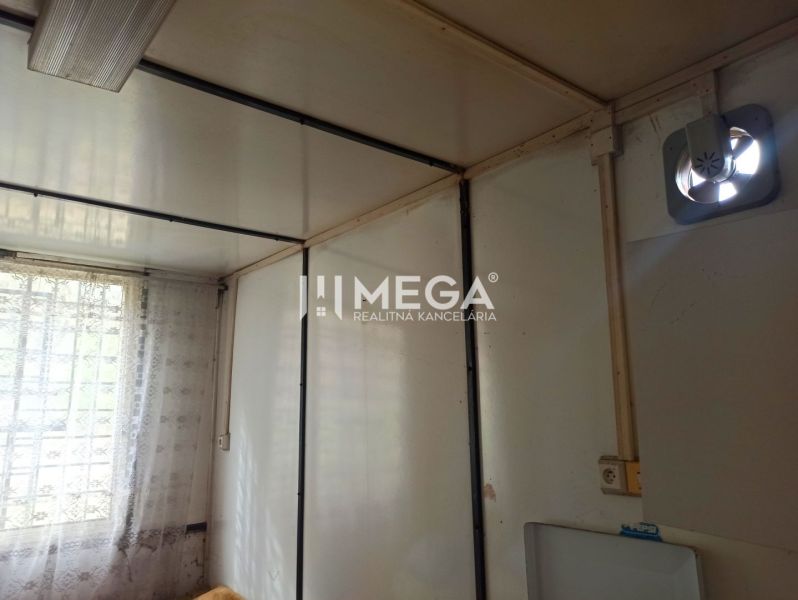 Interior with a curtain on the window and a fan, suitable for garden spaces.