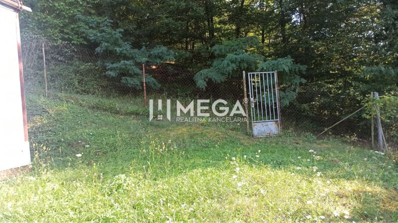 Gardens in Humenné with fencing and a gate, surrounded by greenery and forest in Humenné.