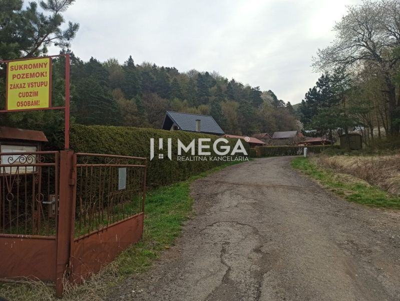 The path leading to the gardens in Humenné lined with trees and fences with a no entry sign.