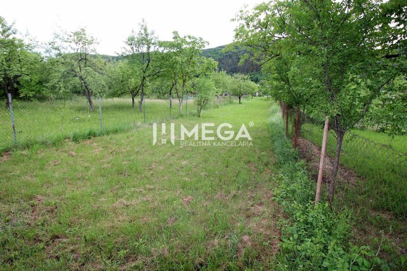 Land for residential use in Ptičí, Ptičí, with grassy area and trees, fenced.