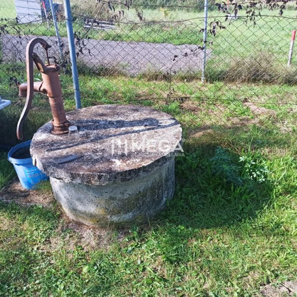 A hand pump on a well on a residential plot by the road in Humenné.