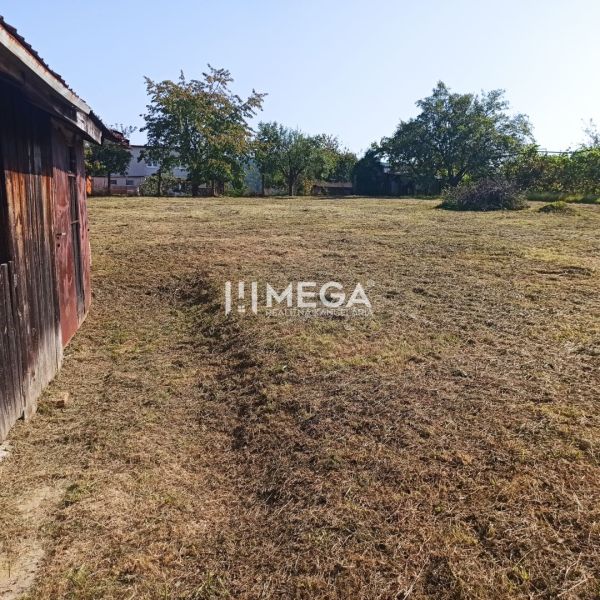 A garden with a grass lawn on a residential plot on a street in Humenné.