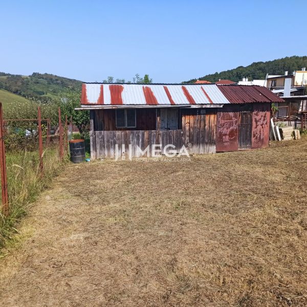 Wooden structure with a metal roof on residential land in Humenné.