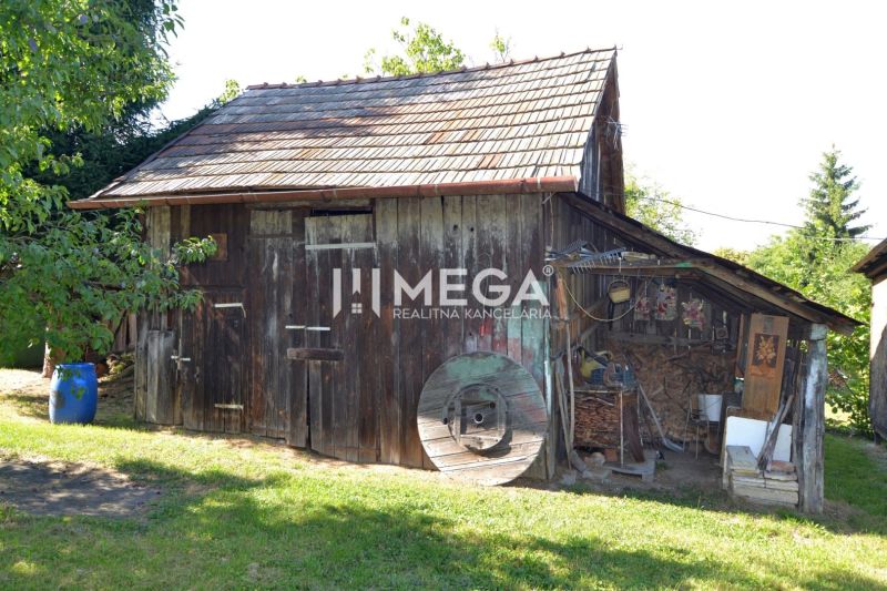 A family house in Hažín nad Cirochou with a wooden cottage and accessories in the yard.
