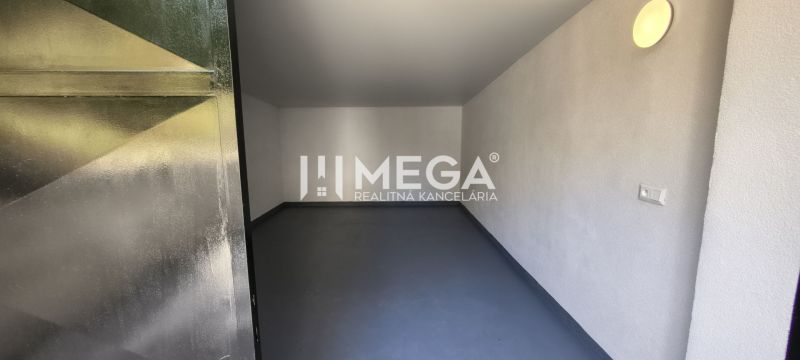 Interior in a 4-room apartment with white walls and gray flooring.