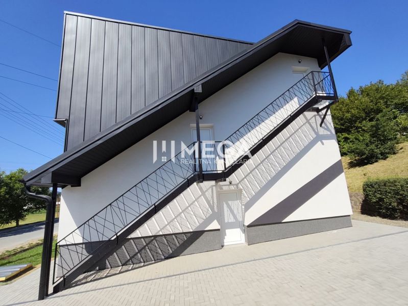 Exterior of a 4-room apartment in Jasenov with a modern facade and an outdoor staircase.