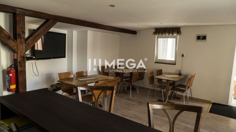 Interior with wooden beams, tables, and chairs in the guest areas of hotels and guesthouses.