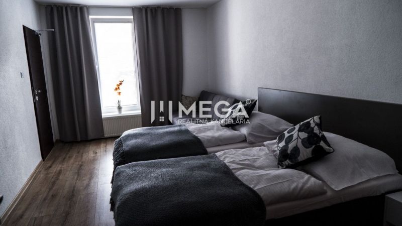 A hotel room with two beds, decor, and a wooden decor floor.