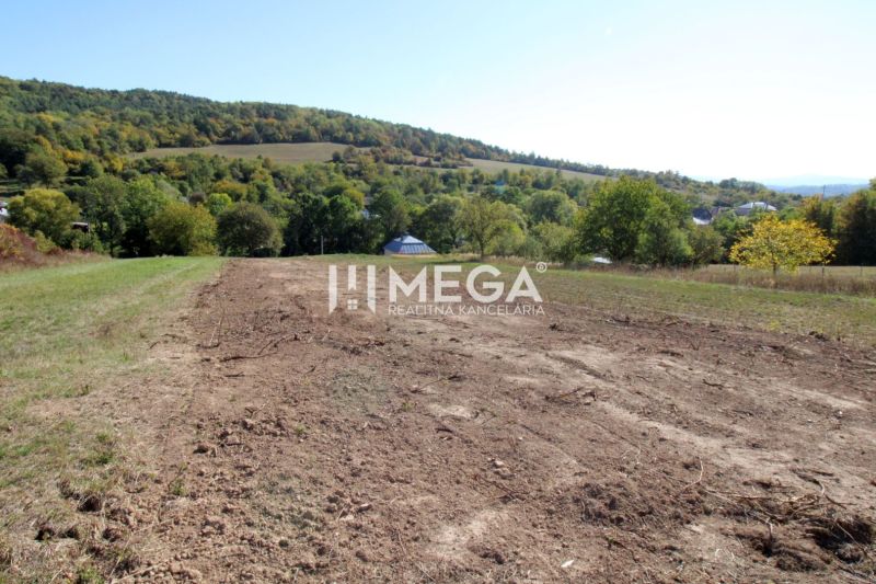 A residential plot on the outskirts of Vyšné Ladičkovce, surrounded by greenery and hills.