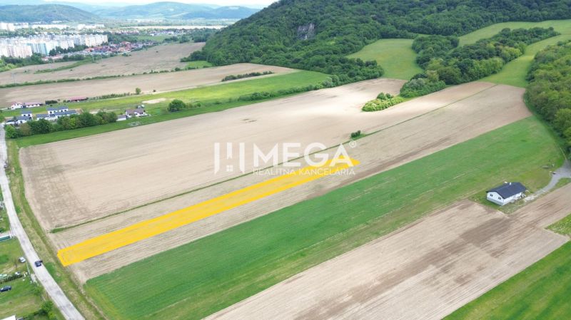 Hilly landscape near Jasenov with residential plots, surrounded by fields and forests.