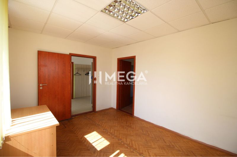 Office space with wood-patterned flooring and built-in ceiling lighting.
