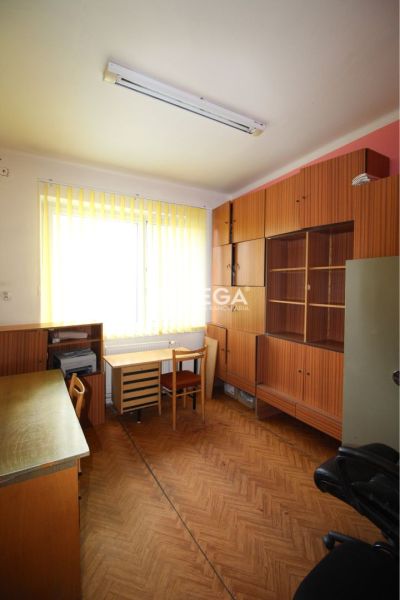 Offices with furniture and flooring featuring a wooden decor, light through vertical blinds.