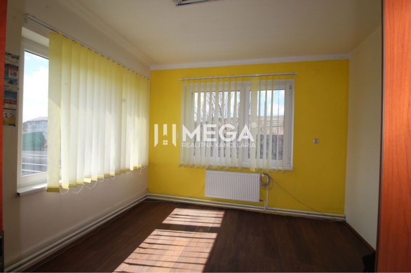 Offices with wood-patterned flooring, yellow walls, and vertical blinds.