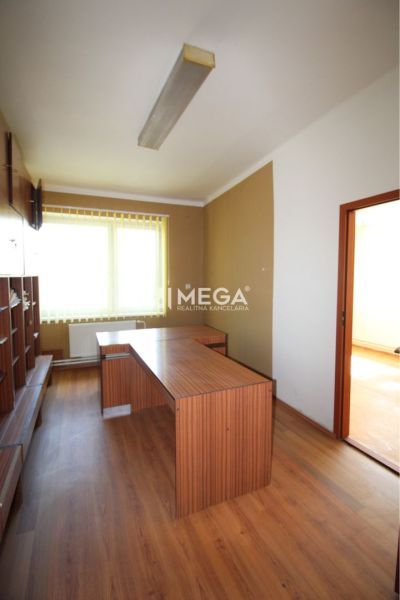 An office interior with a desk and a wooden decor floor.