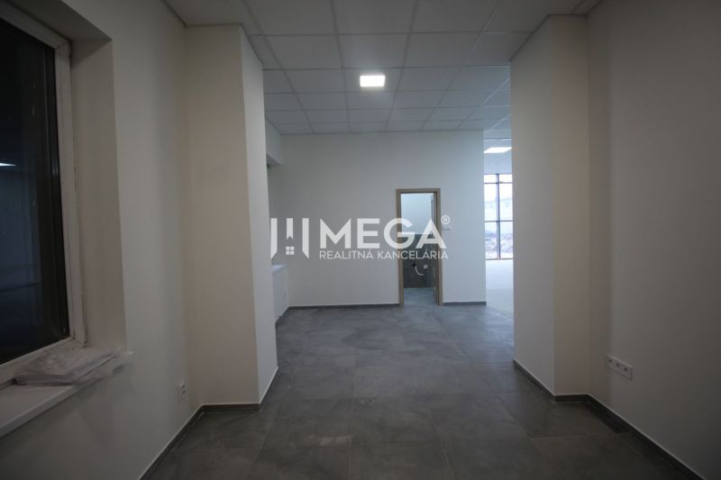 Interior of commercial spaces with tiles and a window, neutral colors, well-lit rooms.