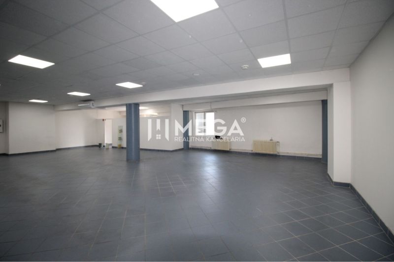 The interior of commercial spaces with dark gray flooring and white walls.