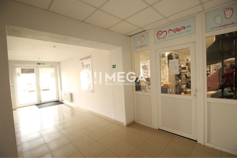 Commercial premises with tiles and glass doors, in a bright interior.