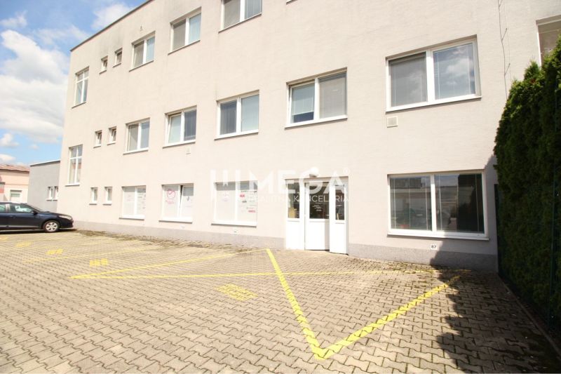 Commercial premises on Tolstého Street in Humenné with parking spaces and a white facade.