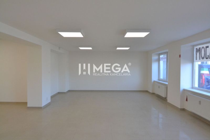 Interior of commercial spaces with ceramic flooring and large windows for natural light.