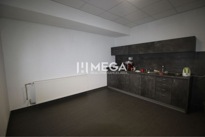 Offices with a kitchenette and a radiator, flooring with decor in the offices.