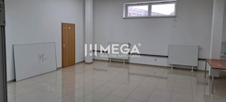 Offices with white walls and a window, floor with wood decor, desk in the corner.