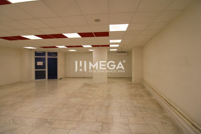 Commercial premises with ceramic tiles, large lighting, and walls in a neutral color.