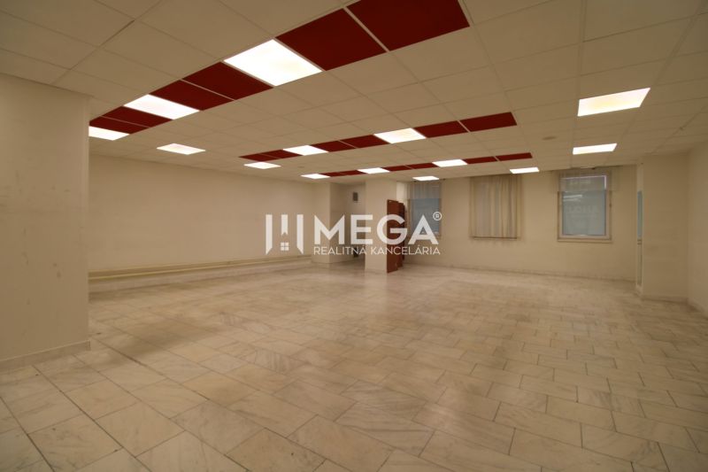 Spacious commercial spaces with ceramic flooring and a coffered ceiling.