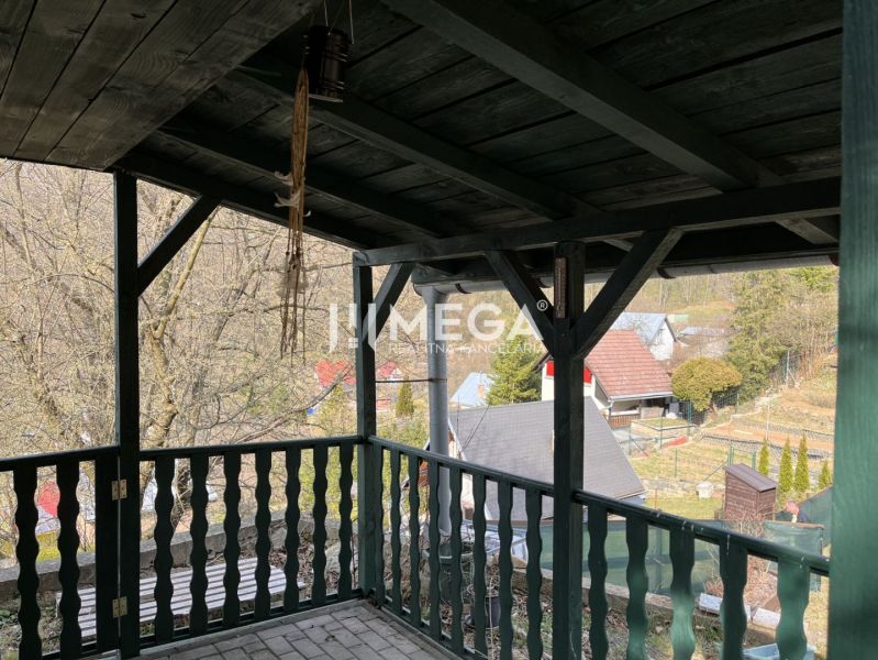 Covered terrace with a view of the gardens in Humenné, ZO Poniklec, features wooden decor.