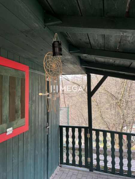 Garden in ZO Poniklec, Humenné, with a wooden terrace and a dreamcatcher.