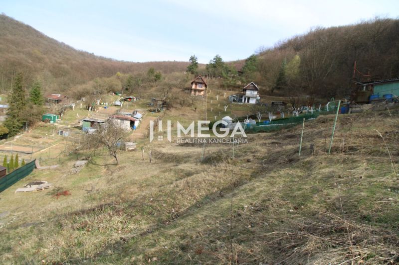 Gardens on the slope in Humenné at ZO Poniklec with several wooden cabins.